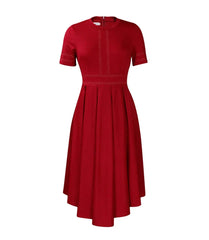 A red short-sleeved A-line dress with white stitch detailing and a pleated high-low skirt.