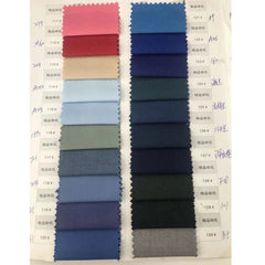 A fabric swatch book displaying a variety of blue and neutral color samples for men's suits.