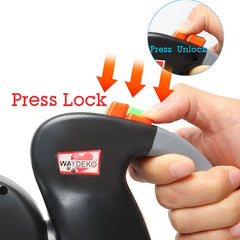 A hand operates the color-coded locking buttons on a black dual retractable dog leash handle.