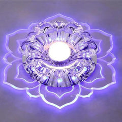 A modern crystal ceiling light shaped like a flower with a glowing purple acrylic base.