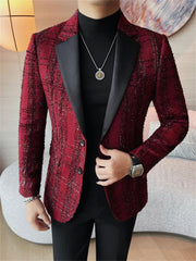 A man wears a slim-fit, burgundy plaid blazer with black notched lapels over a black turtleneck.