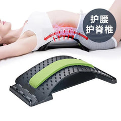 A black adjustable lumbar support device with a green foam strip is shown being used by a person lying on their back to stretch their spine.