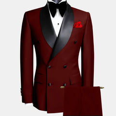 A burgundy double-breasted suit with a black shawl lapel, white shirt, and black bow tie.