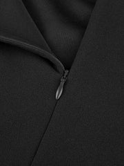 A close-up view of a black dress featuring a concealed zipper closure.