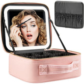 A pink makeup train case with an integrated LED mirror and adjustable interior dividers.