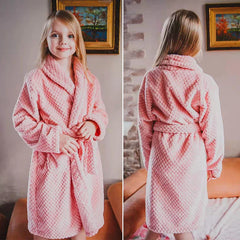 A young girl wears a soft, pink, textured flannel bathrobe with a shawl collar and waist tie.