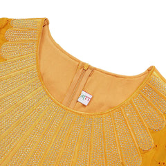 A close-up of a yellow African-style dress featuring a round neckline with silver rhinestone trim.