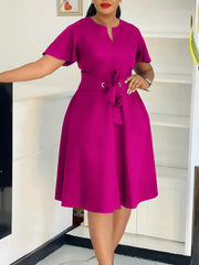 A magenta knee-length A-line dress with short sleeves and a lace-up waist tie.