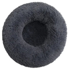 A round, dark gray plush pet bed with a soft, shaggy texture viewed from directly above.