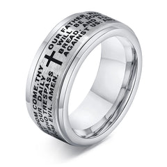 A silver stainless steel spinner ring engraved with the Lord's Prayer and a black cross.