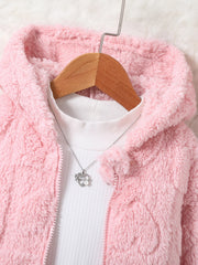 A pink hooded faux-fur jacket for girls worn over a white shirt with a heart pendant necklace.