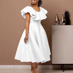 A woman wears a white mid-calf A-line dress with a round neckline and ruffled butterfly sleeves.