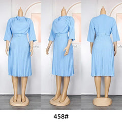 A light blue knee-length dress with a draped neckline, three-quarter sleeves, and a pleated skirt.
