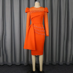 An orange midi sheath dress with lace sleeves, beaded accents, and a side drape detail.