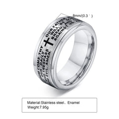An 8mm wide silver stainless steel spinner ring engraved with a cross and the Lord's Prayer.