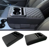 A black quilted PU leather car armrest cushion featuring an integrated dual cup holder.