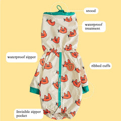 A cream-colored dog raincoat with a red cat pattern, featuring a hood, zipper, and ribbed cuffs.