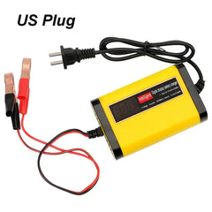 A yellow and black automatic car battery charger with a digital display and alligator clips.