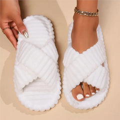 A pair of white corduroy crossband slippers for women with a soft, fuzzy texture.