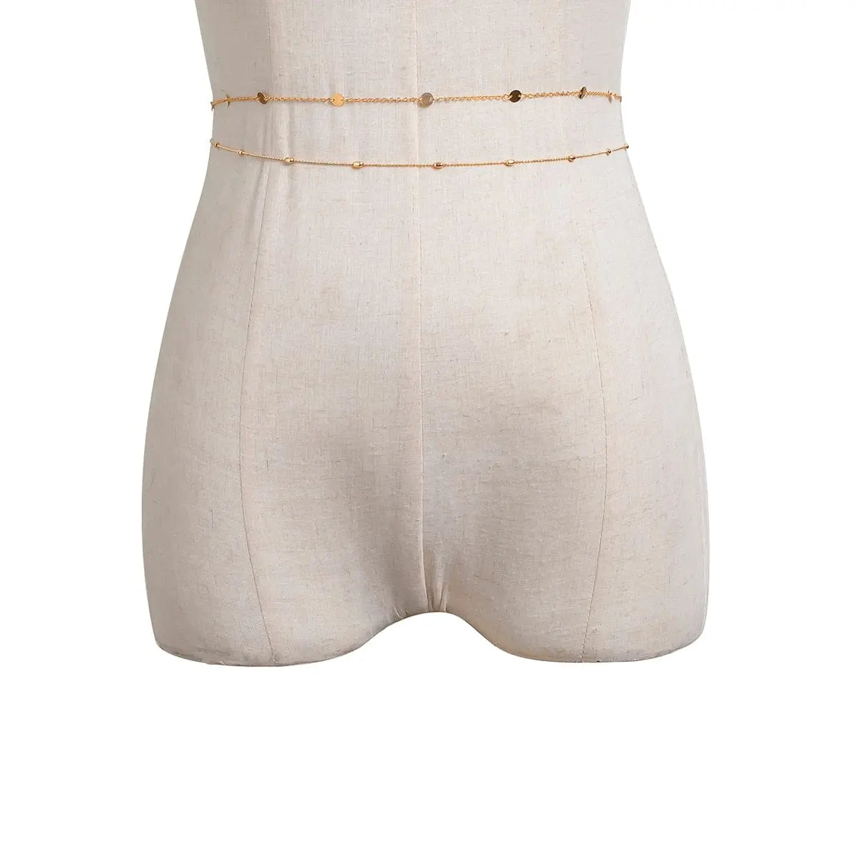 A beige dress form showcases the Sexy Vintage Aesthetic Belly Chain—a thin, gold waist chain with small bead links, wrapped twice for a stylish Y2K streetwear summer look and perfect as women’s fashion body jewelry.