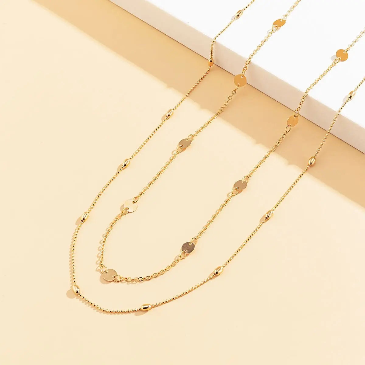 The Sexy Vintage Aesthetic Belly Chain features thin beads and links, perfect as a Y2K streetwear-inspired waist chain belt for summer women’s fashion—a stylish body jewelry piece displayed on a pale beige and white platform.