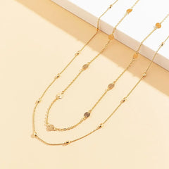 The Sexy Vintage Aesthetic Belly Chain features thin beads and links, perfect as a Y2K streetwear-inspired waist chain belt for summer women’s fashion—a stylish body jewelry piece displayed on a pale beige and white platform.