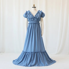 A blue bohemian maternity maxi dress with a V-neck, ruffled sleeves, and a smocked waist.