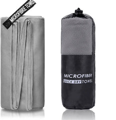 A grey microfiber towel shown unfolded next to its matching black mesh carrying pouch.