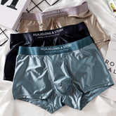 Three pairs of smooth, satin-like men's boxer briefs in blue, black, and beige.