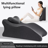 A dark gray, contoured memory foam pillow designed for comfortable prone or upright support.