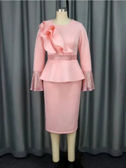 A light pink knee-length sheath dress with a ruffled bodice, sequined cuffs, and a belted waist.