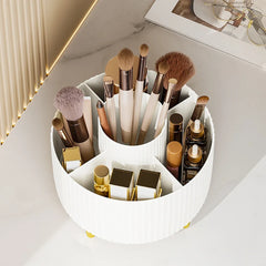 A white, circular, rotating desktop organizer with five compartments holding makeup brushes and items.
