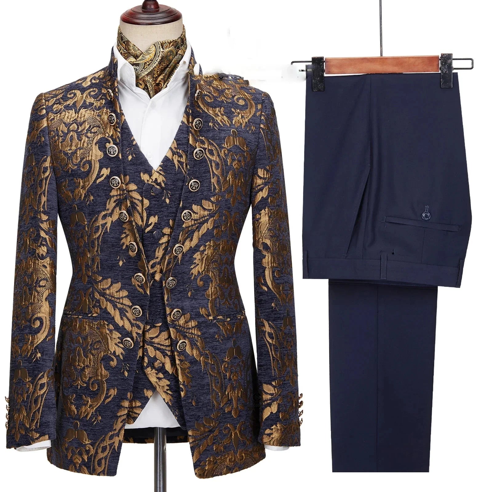 A three-piece men's suit featuring a navy and gold floral jacquard blazer and vest with solid pants.