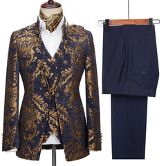 A three-piece men's suit featuring a navy and gold floral jacquard blazer and vest with solid pants.