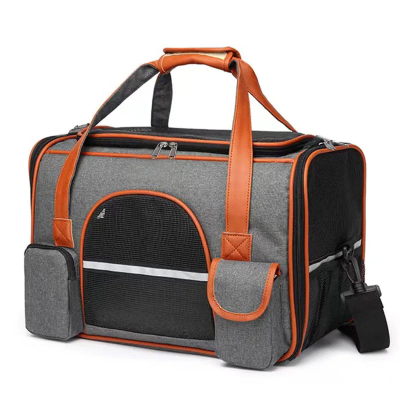 A grey and orange soft-sided pet carrier with mesh windows and pockets on a white background.