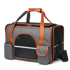 A grey and orange soft-sided pet carrier with mesh windows and pockets on a white background.