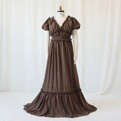 A brown bohemian maternity maxi dress with a V-neck, ruffled sleeves, and a smocked waist.