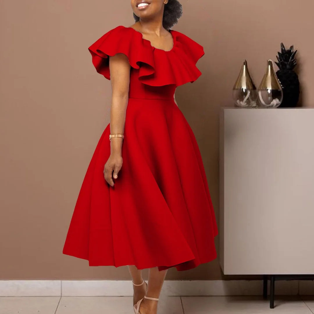A woman wears a red mid-calf A-line dress with a round neckline and ruffled butterfly sleeves.