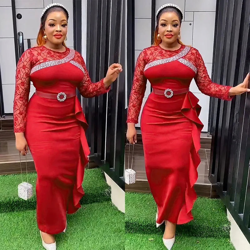 A woman wears a long-sleeved red dress with lace detailing, a belted waist, and a ruffled side.