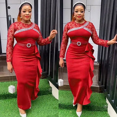 A woman wears a long-sleeved red dress with lace detailing, a belted waist, and a ruffled side.