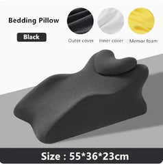 A black memory foam prone sleeping pillow with a contoured shape measuring 55 by 36 by 23 centimeters.