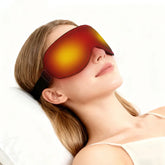 A woman rests while wearing a heated eye mask with a glowing red and yellow light effect.