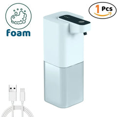 A white automatic foam soap dispenser with a clear reservoir and an included USB charging cable.