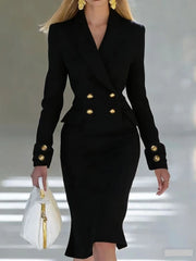 A woman wears a black double-breasted blazer dress with gold buttons and long sleeves.