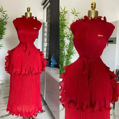 A red sleeveless pleated midi dress with a ruffled peplum waist and a matching tie belt.