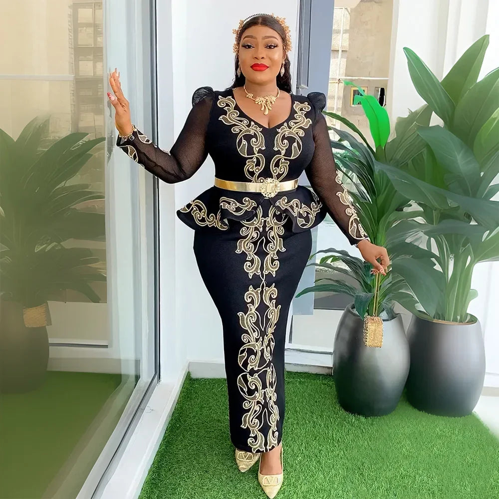 A woman wears a black long-sleeved dress with gold embroidery, a peplum waist, and a gold belt.
