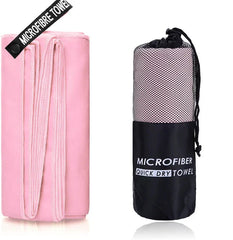 A pink microfiber towel is shown unfolded next to its black mesh carrying pouch.