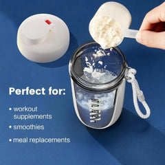 A white protein shaker bottle with a carrying strap and a scoop of powder being poured inside.