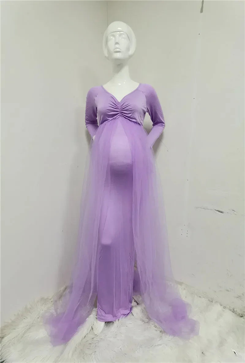 A long-sleeved lavender maternity dress with a V-neck, ruched bodice, and a sheer tulle cape.
