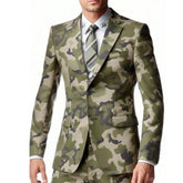 A man wears a two-piece camouflage suit featuring a single-breasted jacket and matching trousers.